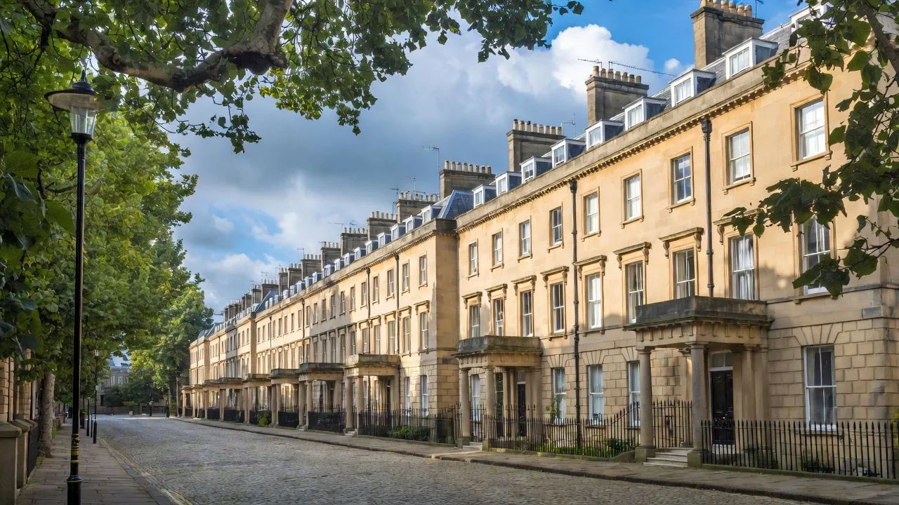 A terrace of Georgian townhouses on a quiet tree-lined street in Bristol
