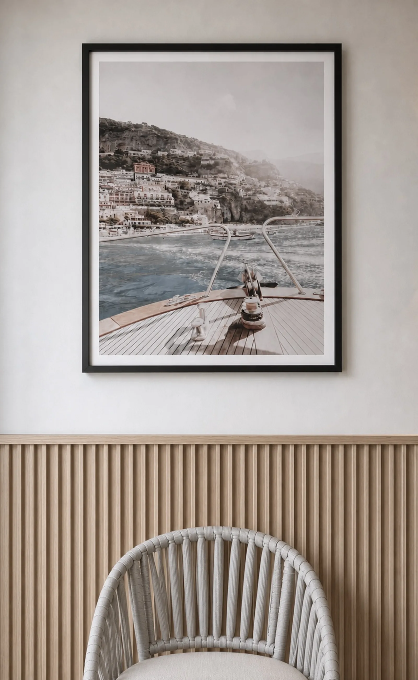 A framed coastal photograph above fluted timber panelling