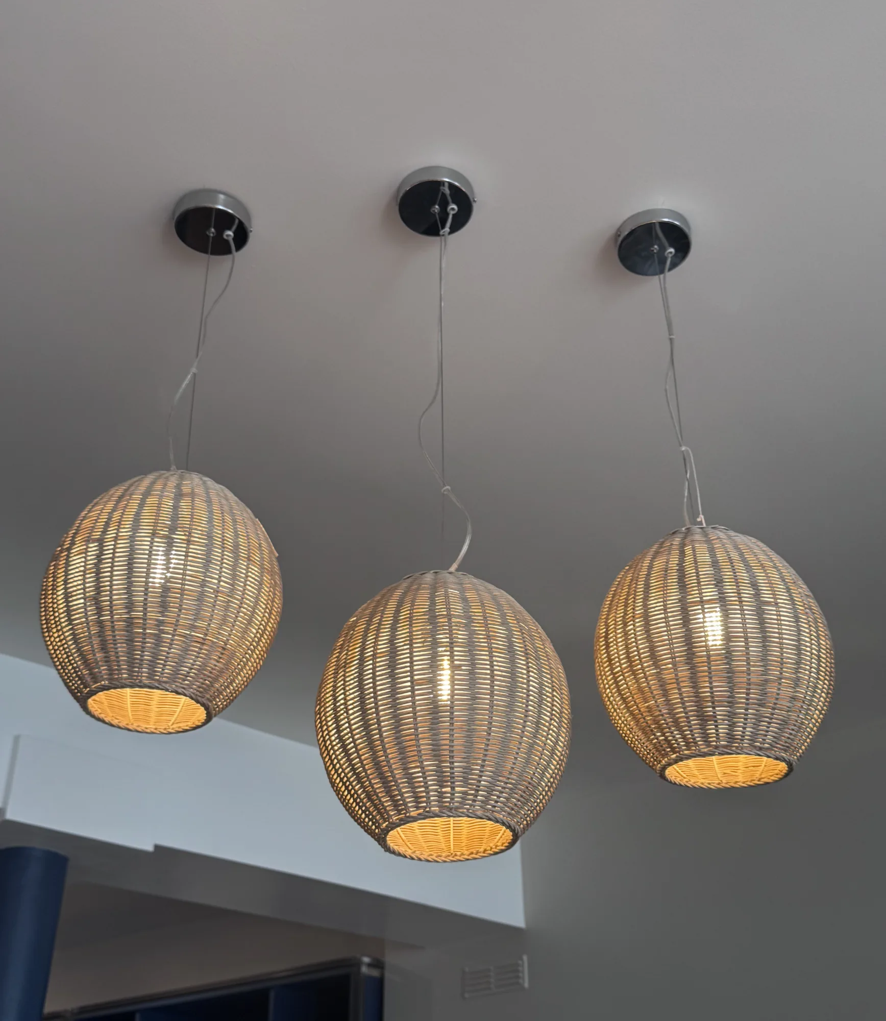 Three round rattan pendants lit above the bar, Amalfi Bar & Cafe, Bideford, Devon