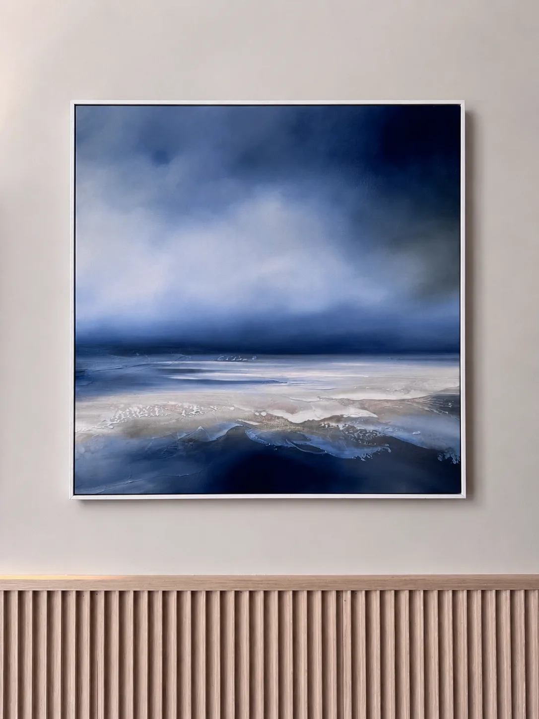 Blue and white seascape painting hung above fluted oak panelling, Amalfi Bar & Cafe, Bideford, Devon