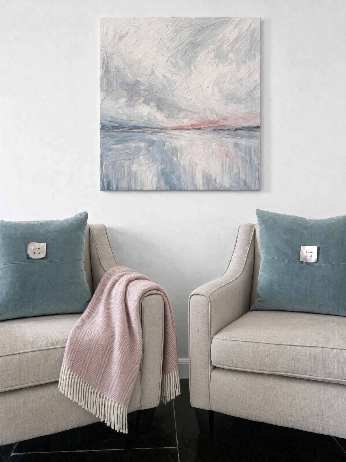 Paired cream armchairs with teal velvet cushions and a pink wool throw, below a stormy seascape painting, Appledore, Devon