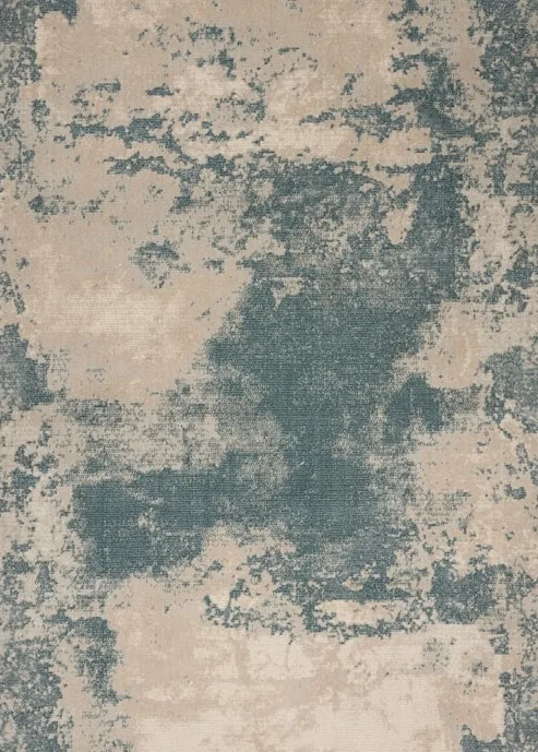 Hand knotted rug in teal and beige on black slate flooring, at the thatched cottage in Appledore, Devon
