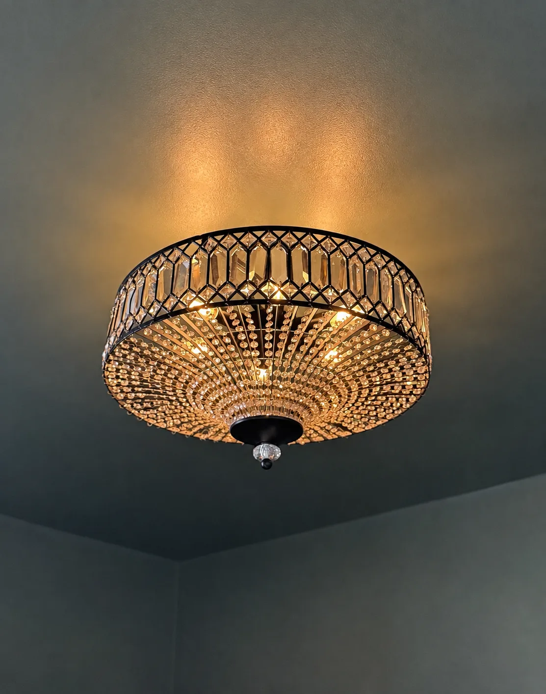 Crystal drum chandelier lit against the deep green function room ceiling, Belluno Restaurant, Bideford, Devon