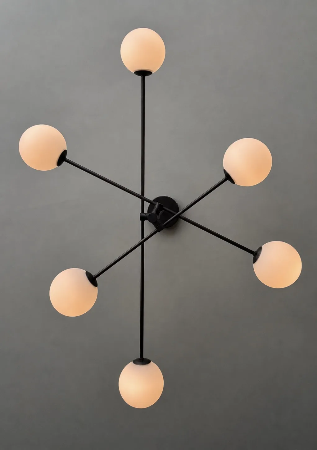 Six armed opal globe ceiling light on a dark grey ceiling, Belluno Restaurant, Bideford, Devon