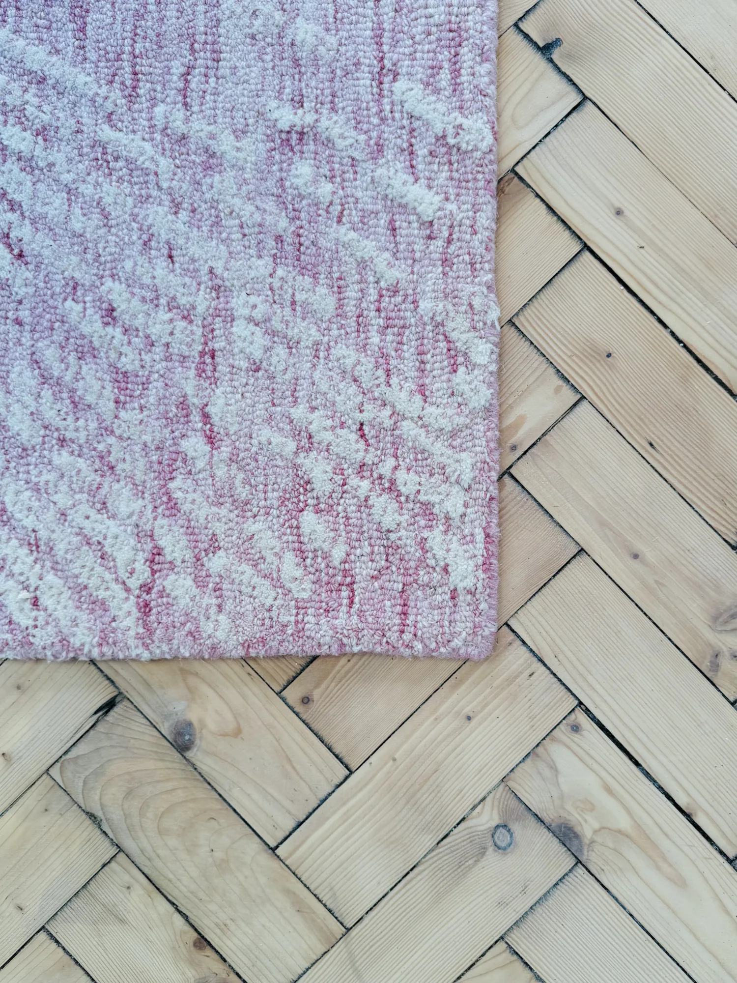Restored parquet flooring with the corner of a pink rug, Stevenstone, Devon