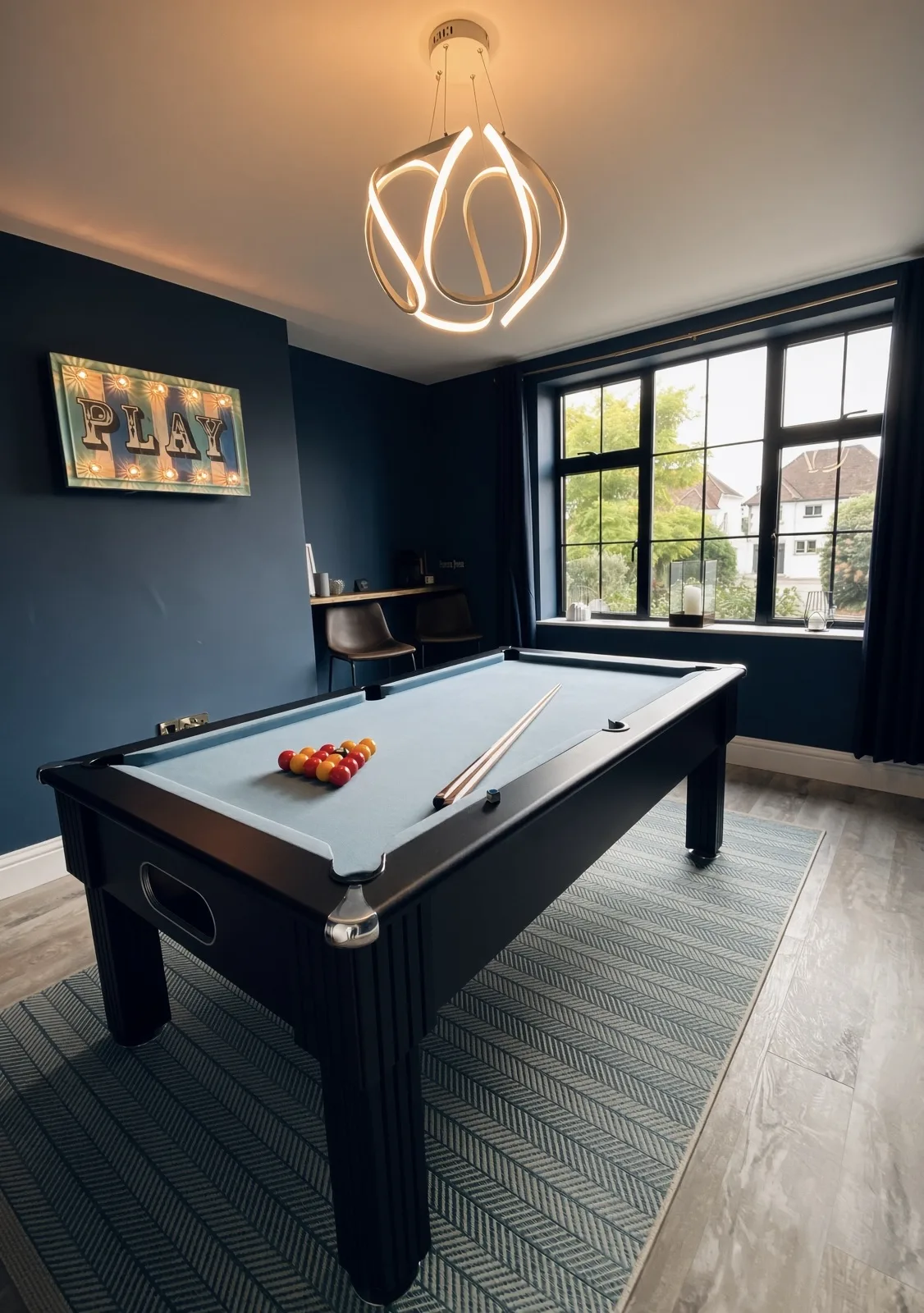 Games room with a pool table, navy walls and a sculptural ceiling light, Topsham, Devon