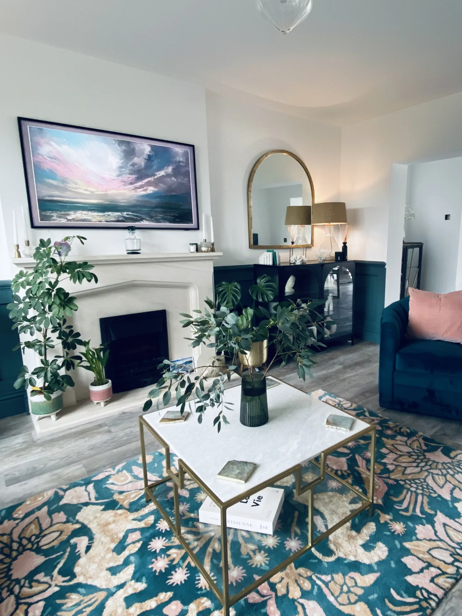 Living room with teal panelling, a limestone fireplace and a patterned rug, Topsham, Devon
