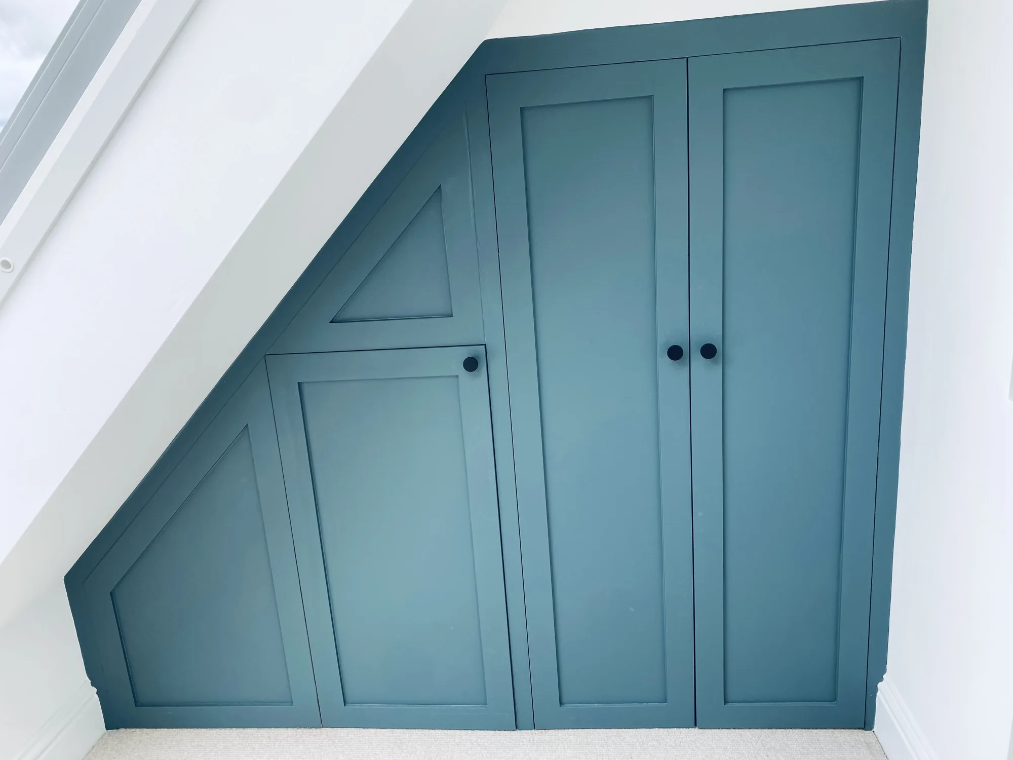 Bespoke teal wardrobes fitted into the eaves of the master bedroom, Topsham, Devon